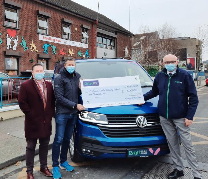 Niall Heneghan Principal of St. Joseph's receive a cheque from Ciaran O'Riordan, Director of Bright Motor Group