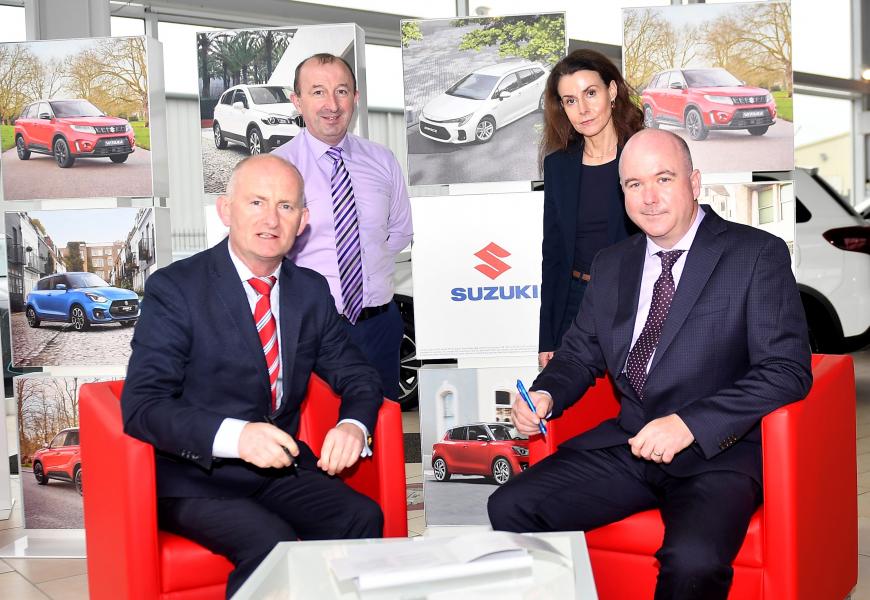 Criostoir Sleator signing contracts with Michael Mc Barron, National Sales Manager, Suzuki Cars Ireland together with Emer Sleator and Martin Mc Anenna).